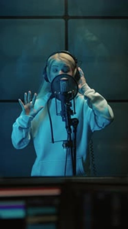 Recording Music in Modern Studio Portrait of Talented Female Singer Singing Song to Microphone