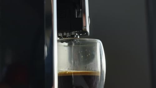 Espresso Pouring Into Glass From Modern Coffee Machine