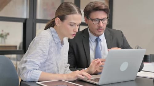 Businessman Talking with Female Worker in Office