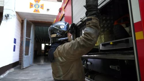 Firefighter Opens Compartment on Fire Engine