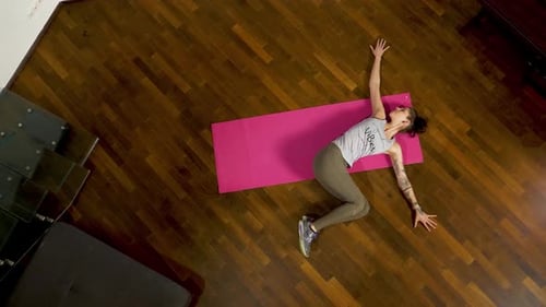 Woman Doing Leg Exercise on Yoga Mat