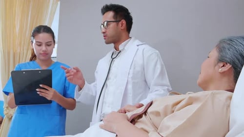 Specialist doctor man and nurse explaining and check with elderly patient in hospital.