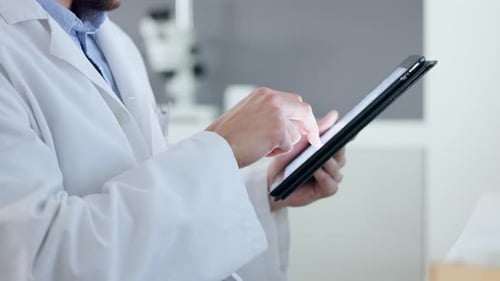 Doctor, professional and worker holding tablet, doing medical research online on internet