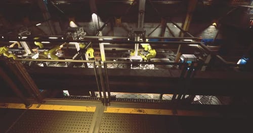 Industrial Automation with Robotic Arms in a Manufacturing Facility at Night