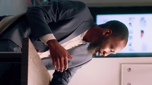 Bearded Man Discussing Data in Modern Office