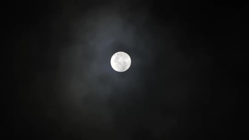 Clouds pass in front of Full Moon in a dark sky 3