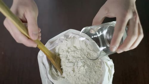 Flour and Water Being Mixed with Spoon