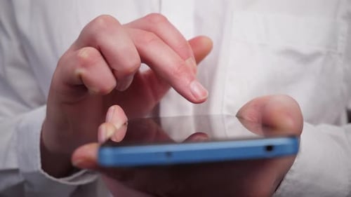 Male Hands Close Up Writing a Message on a Blue Smartphone Front View
