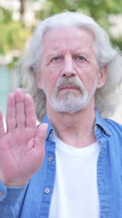 Stop Gesture by Old Man Outdoor