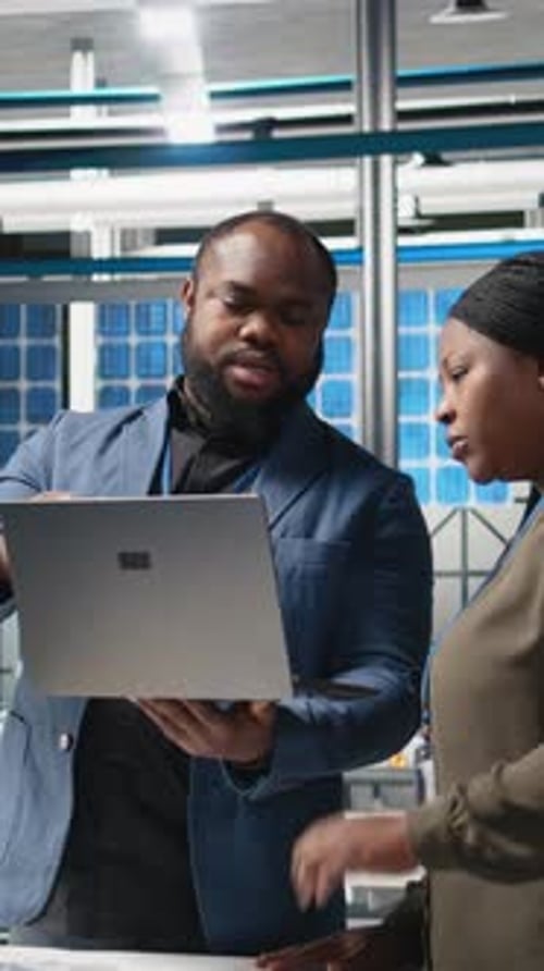 Vertical Video Black Factory Inspectors Engaging in a Briefing Over the Manufacturing Process
