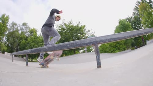 Skateboarder Doing Rail Trick at Urban Skate Park