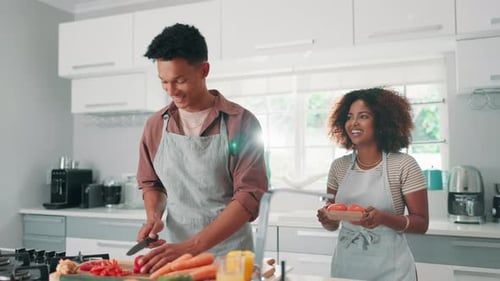 Couple Cooking Vegetables Together in Kitchen