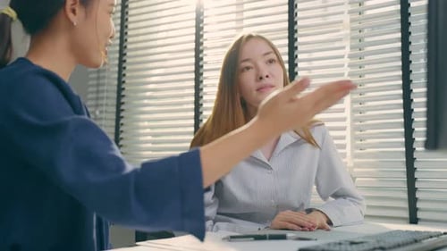 Young Asian business woman work with Caucasian woman manager in office.