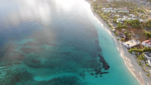 Sunset on a tropical beach in Grenada, aerial reveal