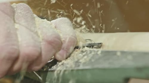 A Close Up of a Man Using a Manual Lathe and Chisel to Shape a Piece of Timber Slow Motion