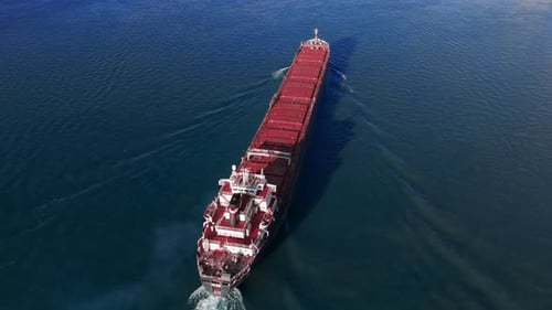 Aerial Above View of Cargo Bulk Carrier Ship Cruising Zoom Shot