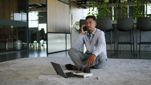 A Business Professional Engaged in a Phone Conversation in a Modern Office Showcasing Effective