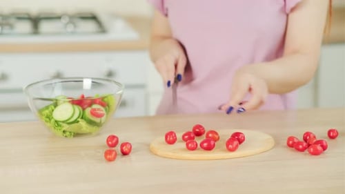 Woman Slicing Cherry Tomatoes in Bright Kitchen