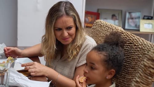 Woman and Girl Enjoying Meal Together at Home