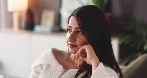 Woman Relaxing Indoors With Hand On Face