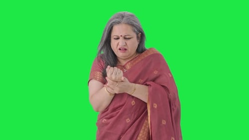 Sick Indian old woman suffering from arthritis Green screen
