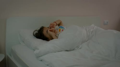 Child Sleeping Comfortably in Bed at Home