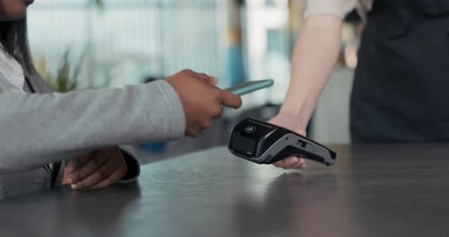 Woman Paying with Phone Using Contactless Technology