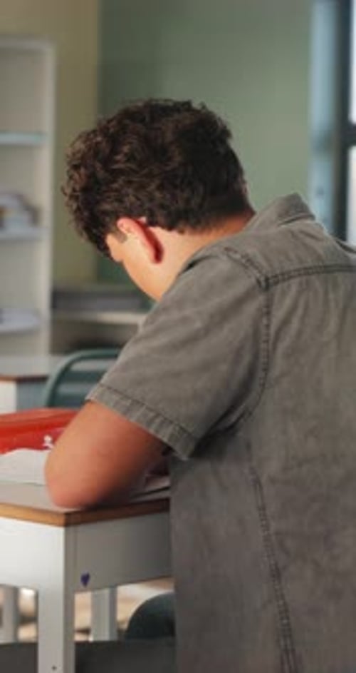 Student, college and teen in classroom for writing notes, studying and learning in lesson