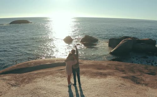 4k video footage of an affectionate young couple looking at the view along the coast