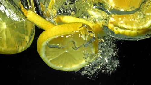 Lemon Slices Falling Into Water in Slow Motion