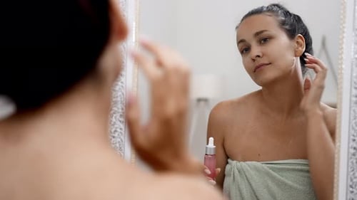 Young Woman Applying Serum for Skincare Routine