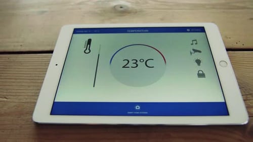 Tablet displaying temperature control smart home application