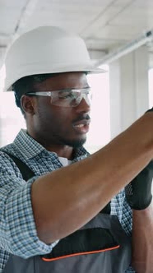Construction Worker Touching an Invisible Screen