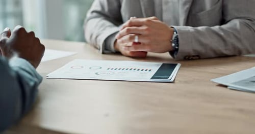 Adults Discussing Financial Data in Workplace Meeting