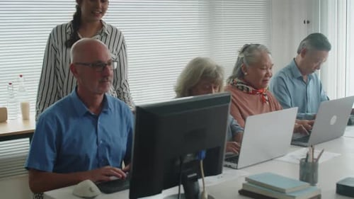 Adults Learning Computers in Tech Education Class