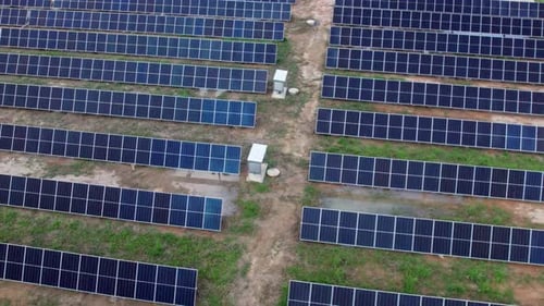 Side Aerial View of Small Industrial Solar Panel Green Energy Farm From Above. Solar Power Concept.