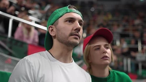 Fans Watching Game at an Indoor Event