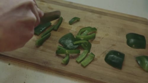 Chopping green peppers on a cutting board. 1080p. 24fps
