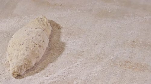Hands spread bread for baking