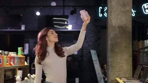 Slim Smiling Girl Taking Selfie on Digital Camera in Digital Store