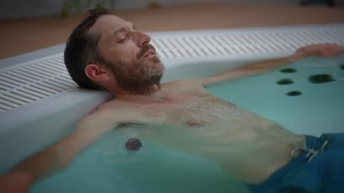 Adult Man Soaking and Relaxing in Hot Tub