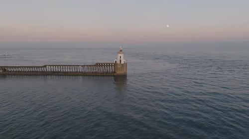 Coastal Lighthouse with Pier at Sunrise