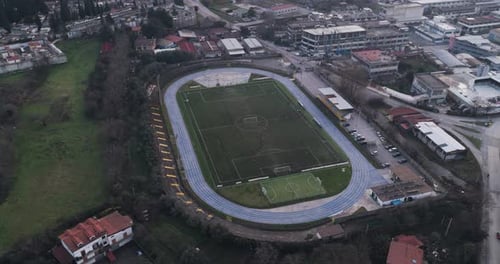 Aerial view of soccer field with running track, Italy.