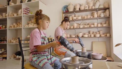 Young Artisans Create Pottery at a Workshop in a Creative Studio Setting
