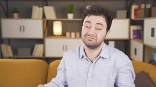 Unhappy man looking at camera.