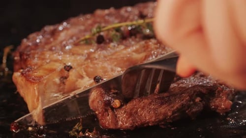 Delicious Steak Cut with Knife and Fork Close Up