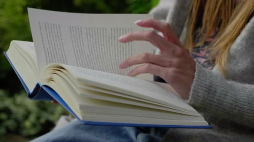 Woman Reading Book Outdoors in Natural Light