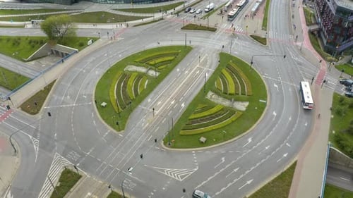Aerial drone shot over Grunwaldzkie roundabout in Krakow, Poland with light traffic movement at dayt
