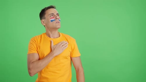 Man Wearing Paint Standing in front of Green Screen