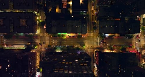 Well-lit streets of New York at night time. Traffic of metropolis from bird's eye view.